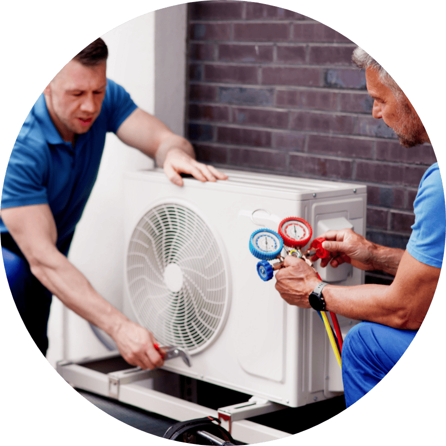 Technicians performing HVAC maintenance on an outdoor air conditioner in Ottawa, KS.